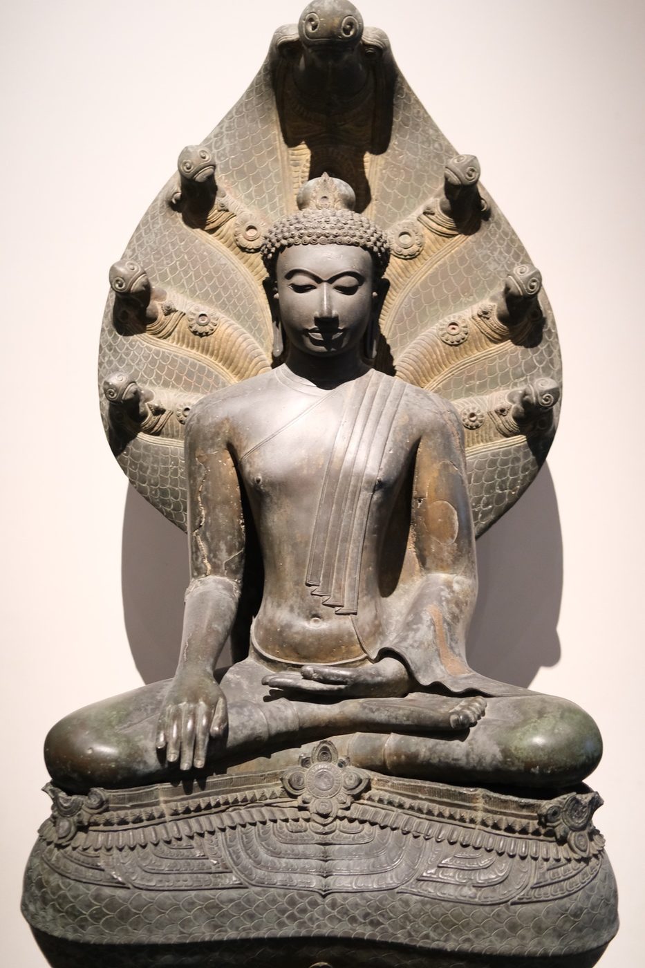 Buddha in the gesture of touching earth and sheltered by Naga's hood